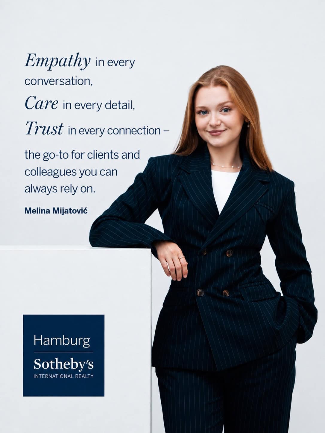Professional woman in a suit at Hamburg Sotheby's International Realty.