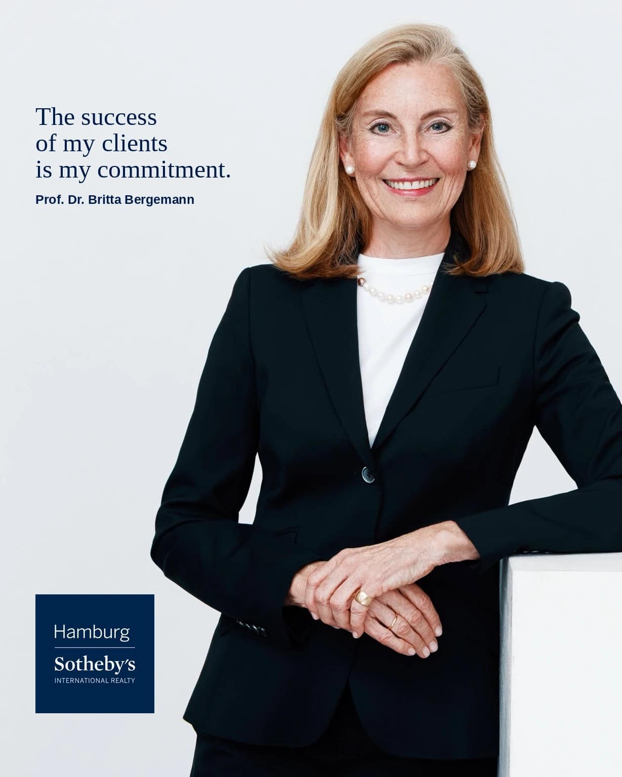 Professional woman in business attire against a white background.